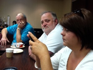 David is the furthest one away in the blue shirt. Walt Wojnar is in the white shirt and former Knox County School Board Member Cindy Buttry is preparing to educate the Tuesday Morning Breakfast Club about something from her phone. 