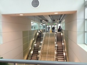 The view of the escalator and stairs that lead from the transportation deck to the terminal 