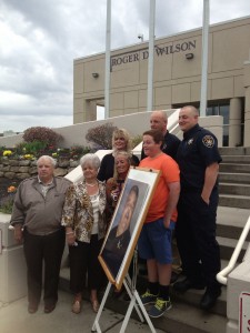 The entire Wilson family with the photograph that will hang inside the Detention facility. 