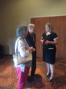 Stacey and Rep. Bill Dunn talking with Jennifer Anders