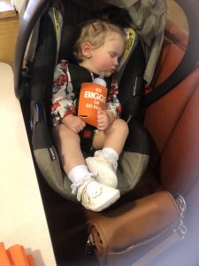 Justin Biggs daughter napping before the meeting, sporting her koozie 