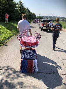 Justin Biggs pulling his daughter in a July 4th festive wagon. 