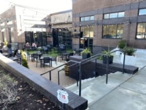 outdoor courtyard, with tv screens and a fireplace