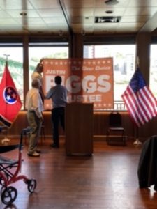 Eddie Biggs (Justin’s dad) and a couple volunteers work to hang the banner