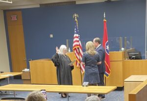 Judge Stevens administering the oath to Davis who was accompanied by his wife Nikki and their two young daughters. 